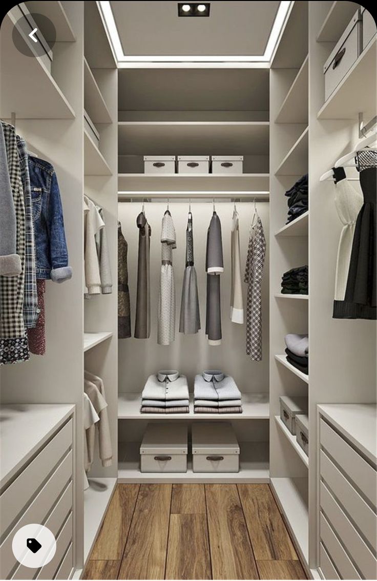 a walk in closet filled with lots of white drawers and clothes on top of shelves