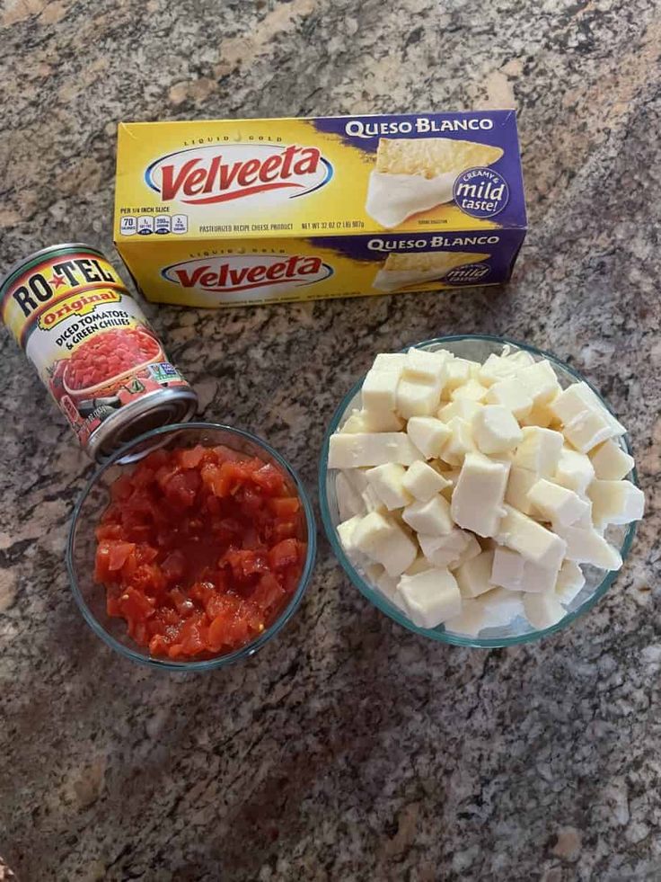 ingredients for tofu, cheese and tomato sauce on a granite counter with a carton of cheetota