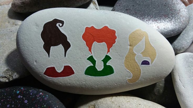 some rocks with different designs on them and one is painted to look like the faces of women