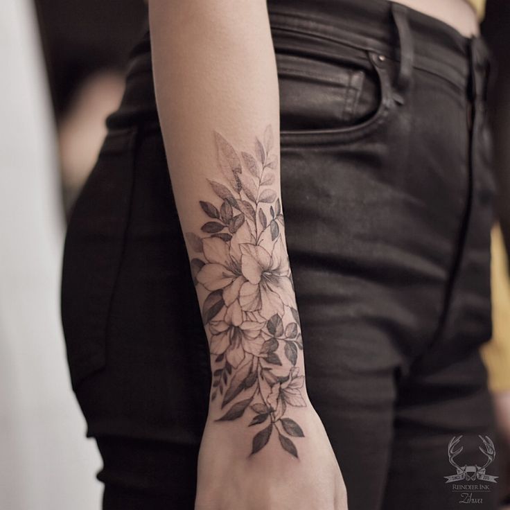 a woman with a flower tattoo on her arm