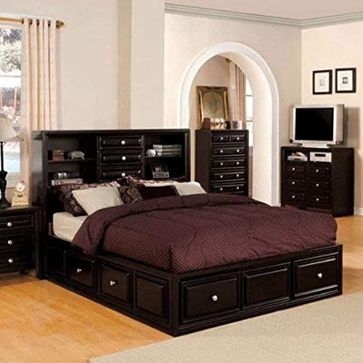 a bedroom with a bed, dresser and tv