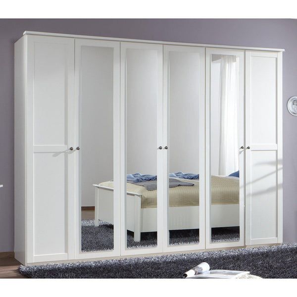 an image of a bedroom setting with white closets and mirrored doors on the wall