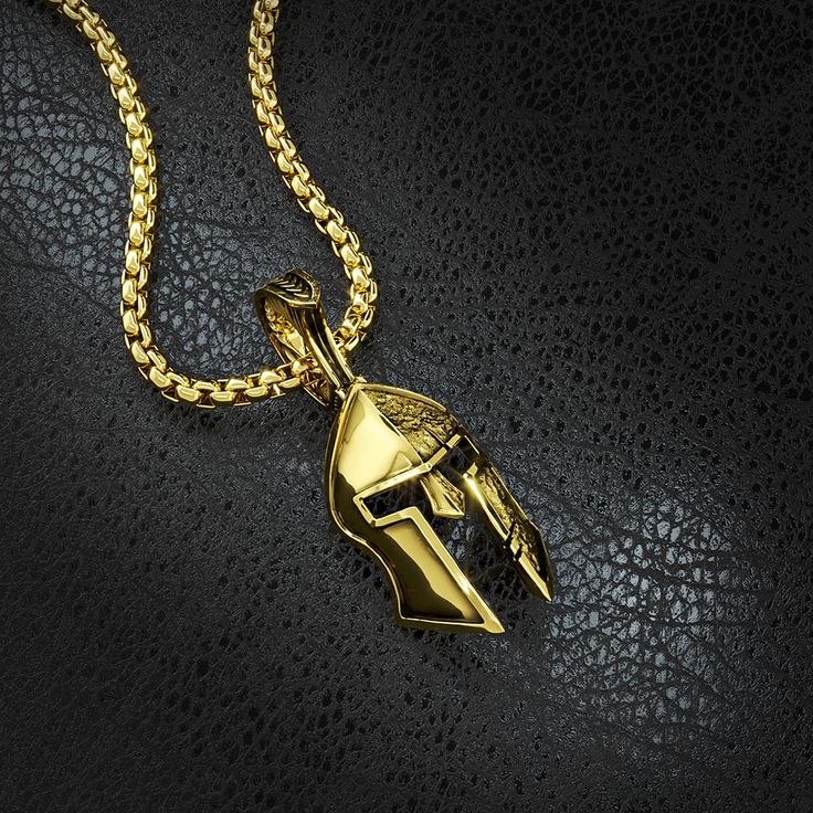 This half polished and half battle-worn Spartan Helmet is a symbol of Strength, Courage, Loyalty, and Power. The Gold Spartan Pendant was created for Free Men who demand the most of themselves. Designed, sculpted and handcrafted in the USA, our Men's Gold and Diamond Spartan Pendant is available in both 14k and 18k gold. 14 karat gold weight is 26 grams and 18 karat gold weight is 31 grams. The Helmet itself measures 32mm (1.25 inches) in length and 21mm (0.82 inches) in width. The overall lengt Bronze Tarnish Resistant Pendant Jewelry, Bronze Tarnish-resistant Pendant Jewelry, Warrior Style Gold Necklaces As Gift, Warrior Style Engraved Pendant Jewelry, Engraved Warrior Style Pendant Jewelry, Gold Pendants For Men, Spartan Helmet, Skull Jewelry, Mens Pendant