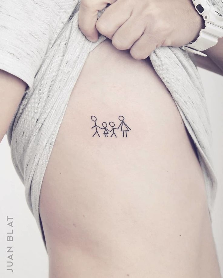 a person with a small tattoo on their stomach that has three people holding hands together