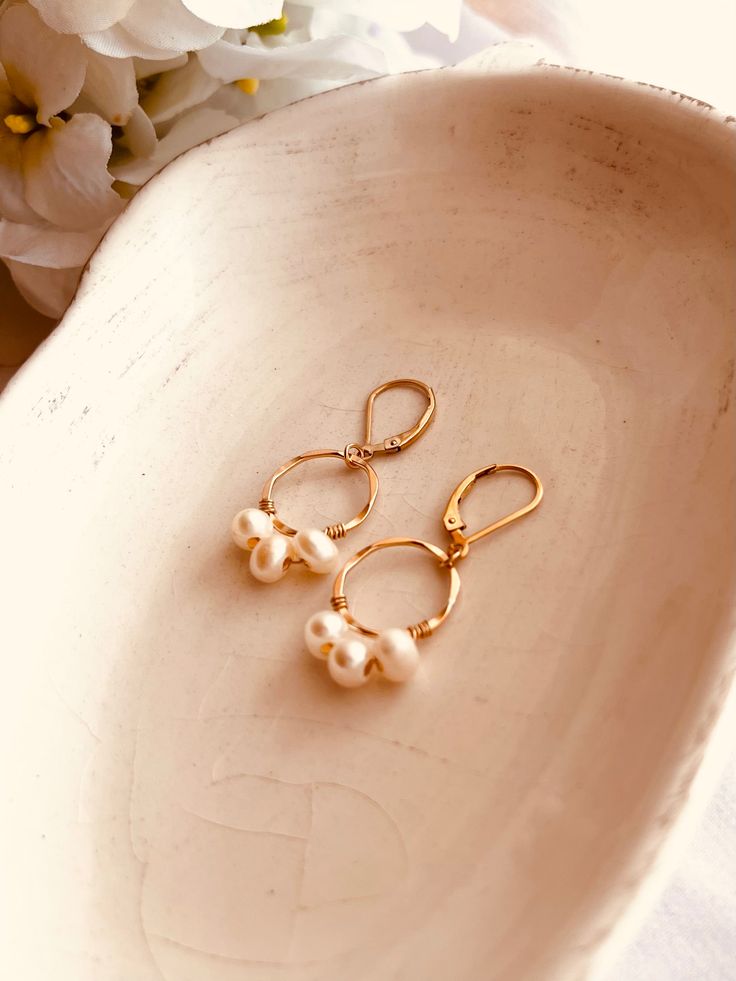 Dainty and minimalist, these earrings can be a perfect gift or a treat for yourself. This list is for a pair of earrings. All metal components are 14k gold-filled, and the pearls are natural, so no two pieces are the same. *Ready To Ship jewelry will ship within 1-2 business days. Handmade Delicate 14k Gold-filled Pearl Earrings, Handmade Minimalist Pearl Earrings For Everyday, Minimalist Handmade Pearl Earrings For Everyday, Delicate Pearl Charm Earrings For Everyday, Handmade Dainty Gold-plated Pearl Earrings, Delicate Everyday Earrings With Pearl Charm, Nickel-free Minimalist Pearl Earrings, Delicate Everyday Pearl Charm Earrings, Gift 14k Gold Pearl Earrings With Ear Wire