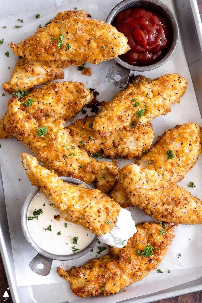 chicken wings with dipping sauce and ketchup on a tray