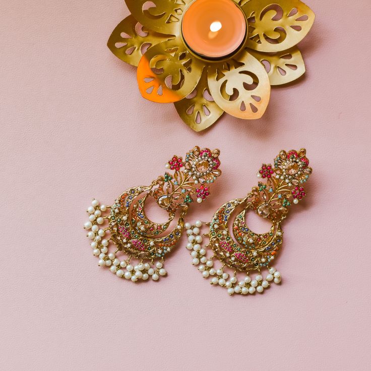 Nauratan timelessness that carry distinct style, intricacy and craftsmanship of a bygone era! A talismanic pair studded with ethereal stones and the grace of pearl moti along with the radiance of traditional and aesthetic identity. Approximate earrings length is 4". Gold-plated on high-quality brass as base metal. Made by order. Kindly allow 5-7 weeks for the delivery of this item. For custom or urgent requests, please contact support@alacouture.com. *Please Note: The multi-colored beadwork migh Diwali Sale, Bygone Era, Faux Stone, The Grace, Base Metal, Multi Colored, Bead Work, Free Gifts, Plating