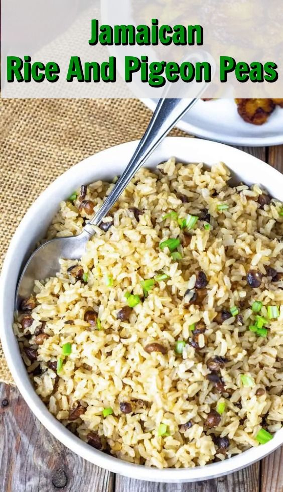 rice and pigeon peas in a white bowl on a wooden table with text overlay that reads jamaican rice and pigeon peas