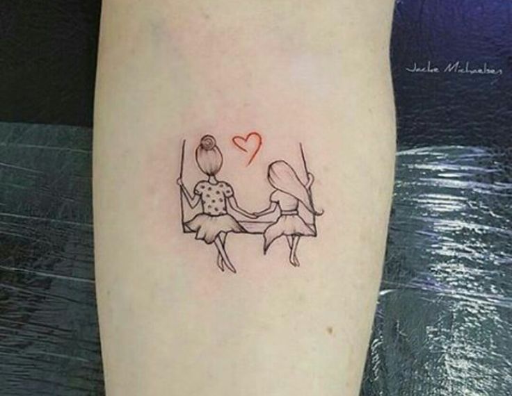 a couple holding hands with a heart tattoo on their arm