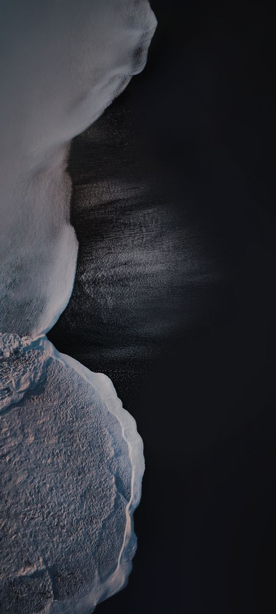 an aerial view of the water and ice