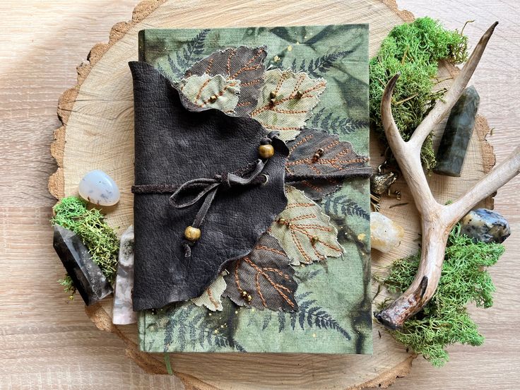 an altered book is sitting on top of a tree stump