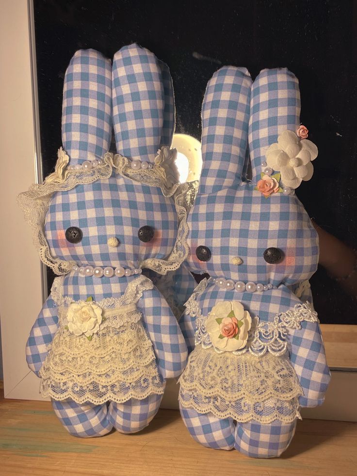 two blue and white stuffed animals sitting next to each other