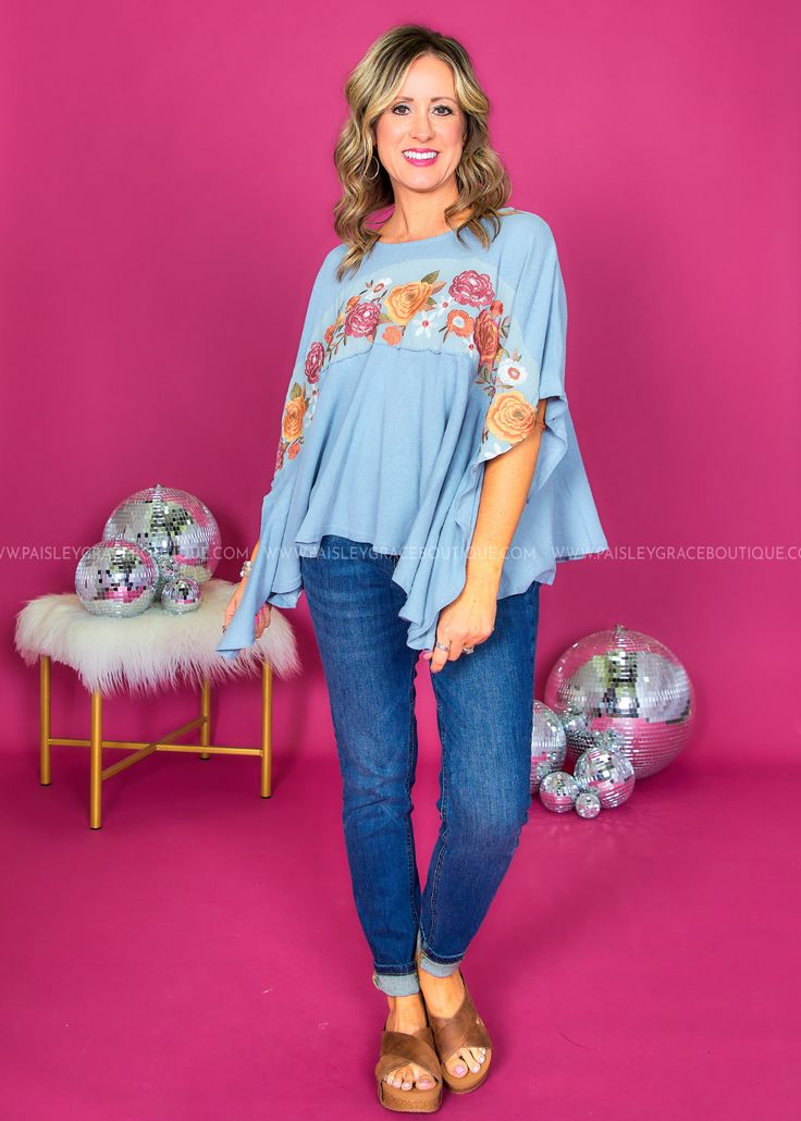 Embracing The Boho Life In My Flowy Floral Blue Top! 🌿💫 #BohoVibes Dusty Blue w/ Rust Embroidery Round Neckline | Mid-length Dolman Sleeves | Split Hemline Soft Denim Feel | Has Stretch | Relaxed Fit Main: 64% Cotton 36% Polyester Contrast: 100% Cotton Measurements Bust Measured Laid Flat Across Front | Armpit to Armpit S/M 25” | M/L 26” Length Measured Shoulder to Hemline S/M 24” | M/L 24” Model: Holly is wearing a S|M Brand: Savanna Jane Blue Floral Embroidered Top For Fall, Blue Floral Embroidery Top For Fall, Light Blue Bohemian Top For Fall, Spring Bohemian Light Wash Tops, Light Blue Cotton Tops For Festivals, Bohemian Denim Blue Tops For Fall, Blue Denim Tops For Festival, Blue Bohemian Tops For Fall, Bohemian Blue Tops For Fall