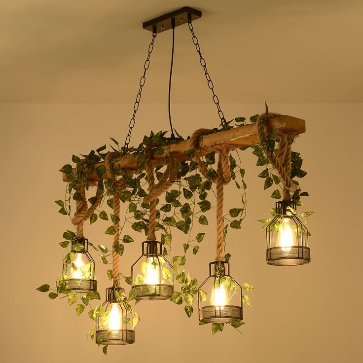 a chandelier made out of mason jars with ivy growing on the top and bottom