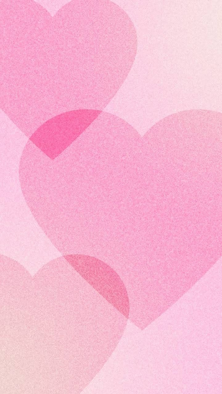 two pink hearts in the middle of a blurry background