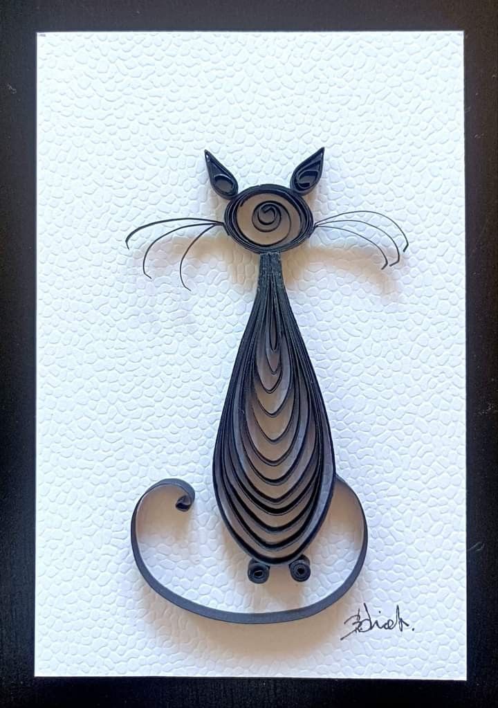 a metal art piece with a cat on it's back