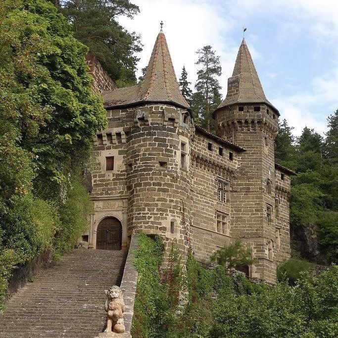 an old castle with stairs leading up to it