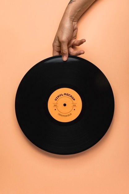 a person's hand on top of an old record