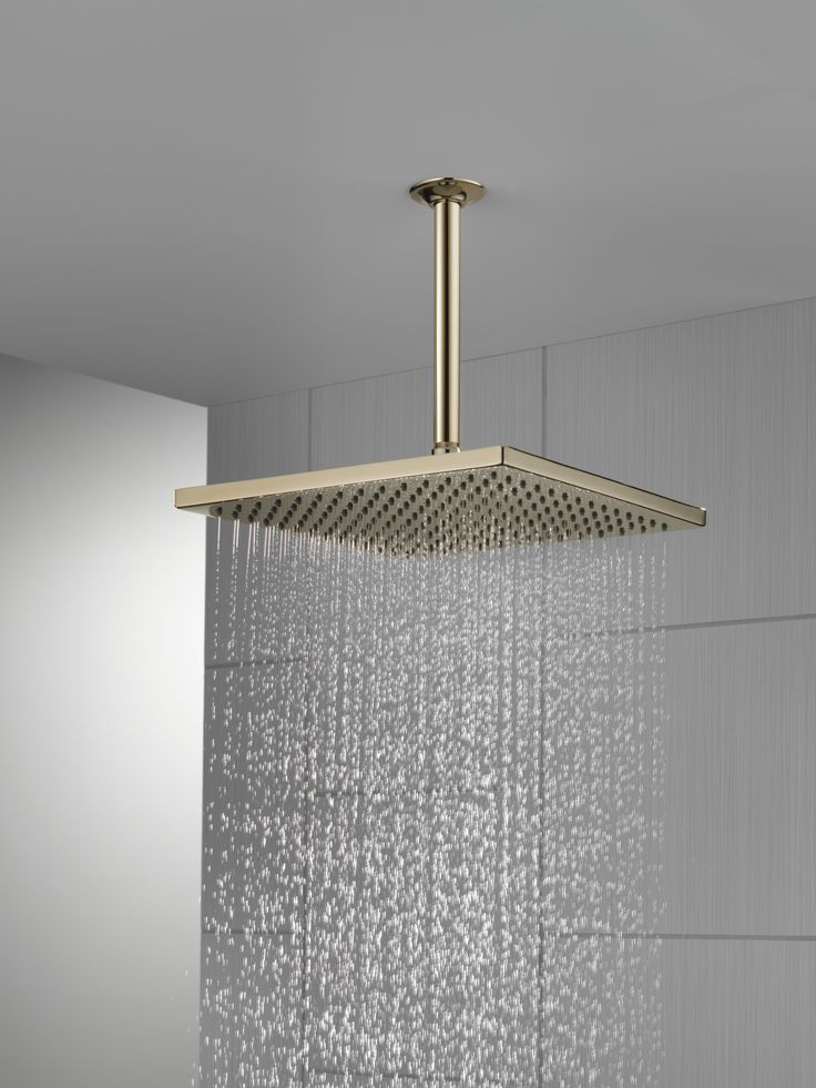 an overhead shower head with water running down it