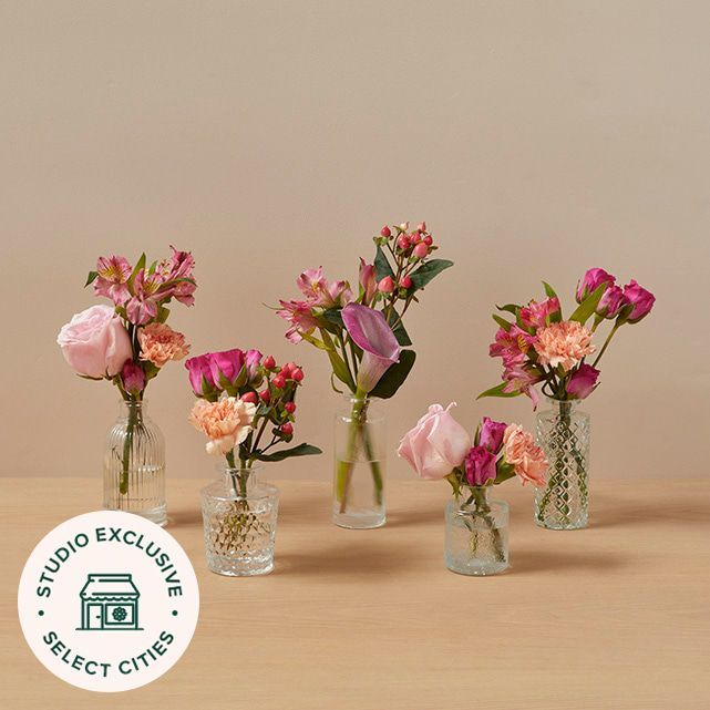 three vases with flowers in them sitting on a table