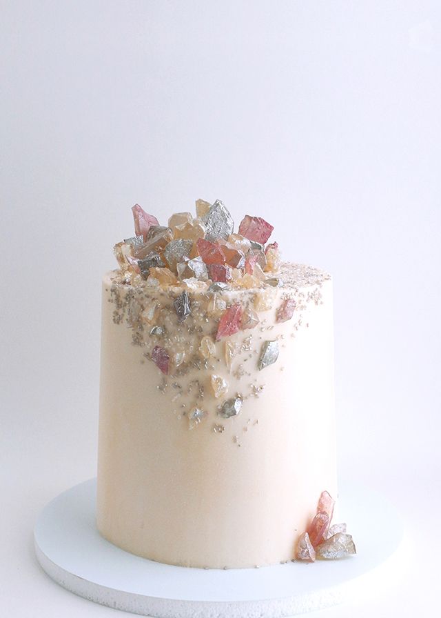 a white cake topped with lots of different types of candies on top of it