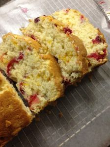 some type of cake that is cut in half on a cooling rack and ready to be eaten