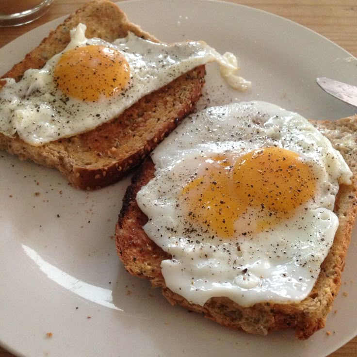 two fried eggs are on top of toast