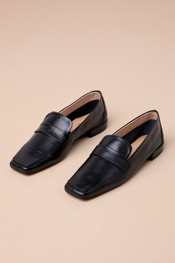 The Intentionally Blank Pinky Black Leather Square-Toe Loafer Flats have an understated chicness that makes them essential for creating effortlessly sophisticated looks! Sleek and smooth genuine leather creates a loafer-inspired silhouette with an exaggerated square-toe upper and a notched vamp with matching strap detail. The slip-on design makes these the perfect choice for everyday styling! Available in Euro sizes only. 0. 75" rubber heel. Lightly cushioned insole. Rubber sole has nonskid mark Chic Square Toe Loafers For Business Casual, Elegant Square Toe Loafers For Office, Sleek Slip-on Formal Flats, Chic Square Toe Formal Loafers, Chic Square Toe Loafers For Formal Wear, Chic Square Toe Loafers For Formal Occasions, Chic Square Toe Loafers For Formal Events, Modern Loafers With Low Heel For Formal Wear, Elegant Evening Loafers With Square Toe