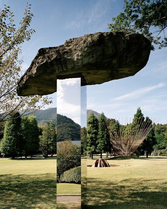 a large rock sitting in the middle of a field