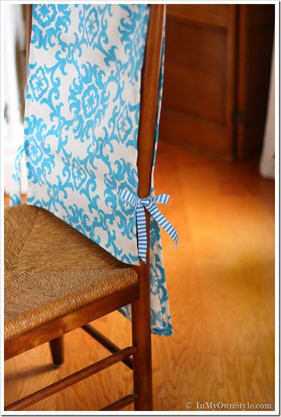 a wooden chair with a blue and white fabric on it