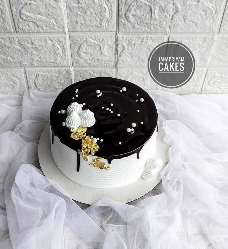 a black and white cake sitting on top of a table