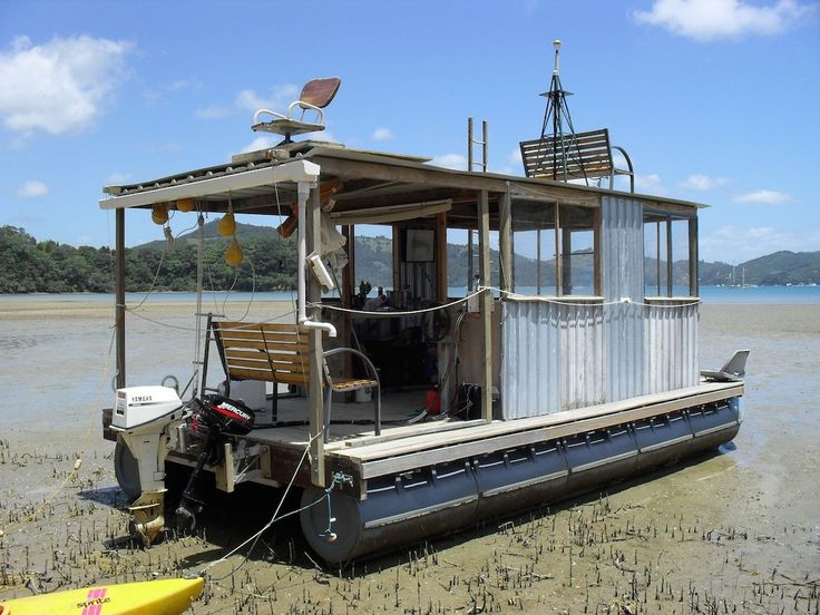 a house boat sitting on top of a sandy beach