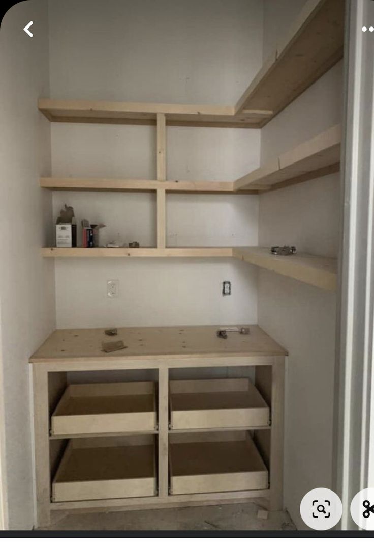 an empty room with shelves and drawers