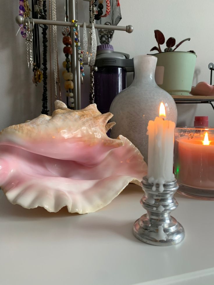 a candle and seashell on a table