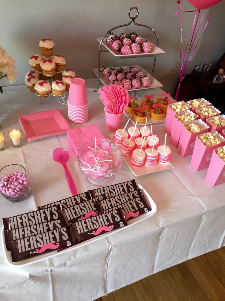 a table topped with lots of desserts and cupcakes