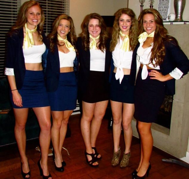 four beautiful young women standing next to each other