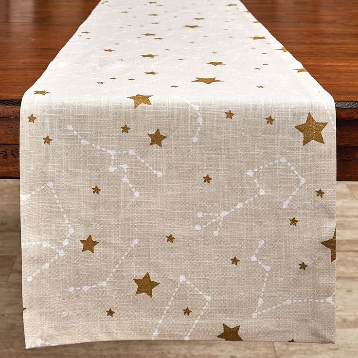 a white table with gold stars on it and a wooden table top in the background