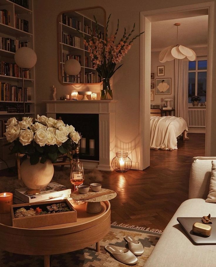 a living room filled with lots of furniture and flowers on top of a coffee table