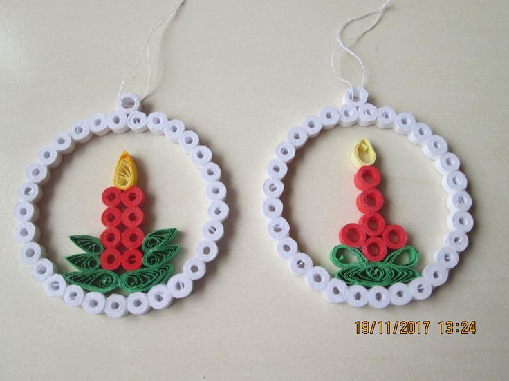 two christmas ornaments made out of plastic beads and string, each with a candle in the center