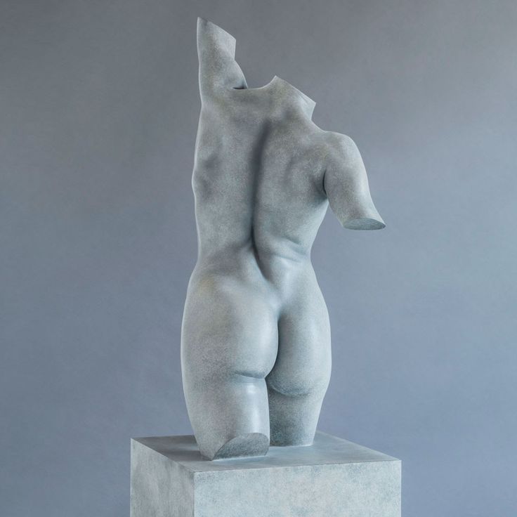 a sculpture is shown in front of a gray background and it looks like the back end of a woman's body