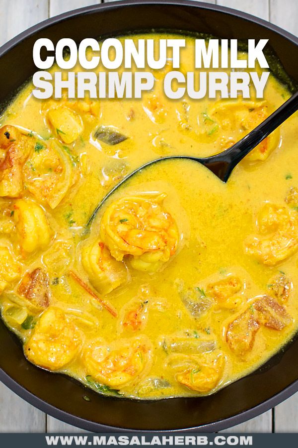 coconut milk shrimp curry in a skillet with a spoon