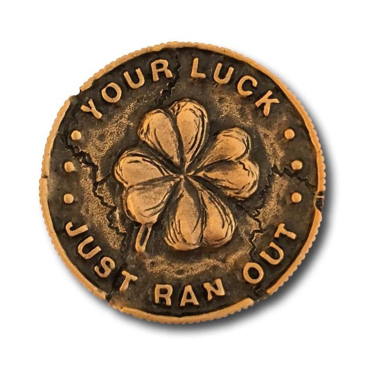 a coin with a four leaf clover in the center that says, your luck is tran out