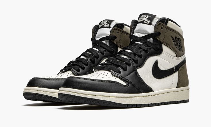 The Air Jordan 1 “Dark Mocha” progresses the timeless silhouette’s association with wearable earth tones. Inspiration for the “Dark Mocha,” a Fall 2020 release, is culled from one of the most popular sneaker collaborations of 2019—Travis Scott’s Air Jordan 1 collection. Though unlike the rapper’s take on the Jordan 1, this “Dark Mocha” iteration features smooth black leather overlays on the forefoot, eyelets, and toe cap. White leather appears on the mid-panel, collar, and perforated toe. Classi Jordan 1 Dark Mocha, Jordan 1 Mocha, Nike Essentials, Popular Sneakers, Jordan 1 High Og, Jordan Sneakers, Air Jordan 1 Retro High Og, Nike Dunk High, Air Jordan 1 Retro High