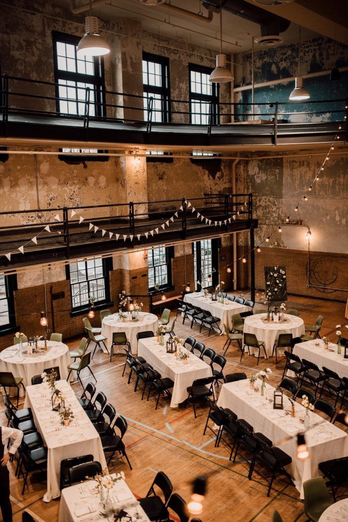 a large room with tables and chairs set up for an event or function in the center