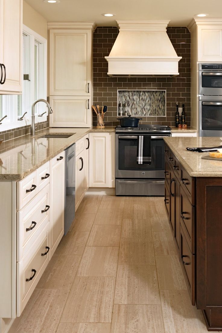 a kitchen with an oven, stove and sink in it's center island area