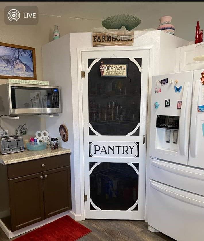 a pantry with magnets on the door and refrigerator freezer next to it in a kitchen