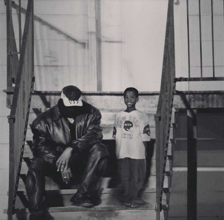 two young men sitting on the steps of a building