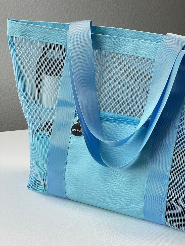 a blue tote bag sitting on top of a table