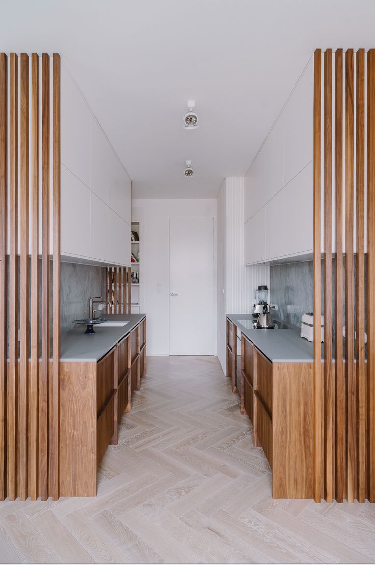 an empty kitchen with wooden cabinets and counter tops on the wall, along with wood flooring