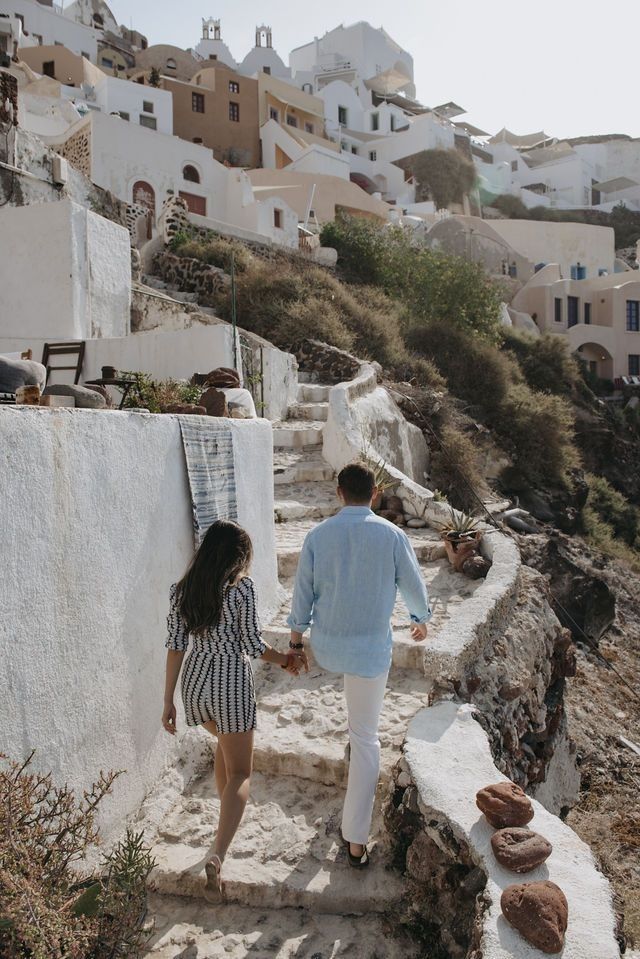 a man and woman walking up some steps